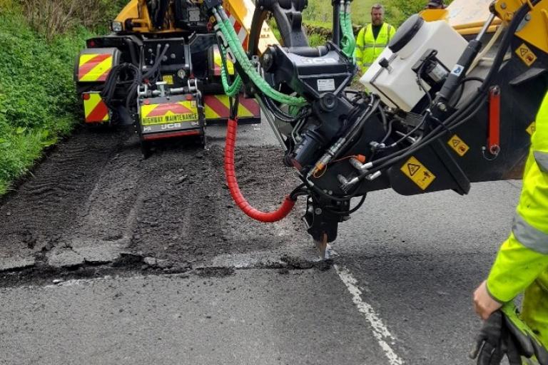 state of the art machine filling in pot holes in St John's in the Vale