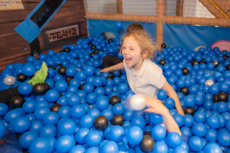 little girl playing in a ball pool at Maryport Activity Centre