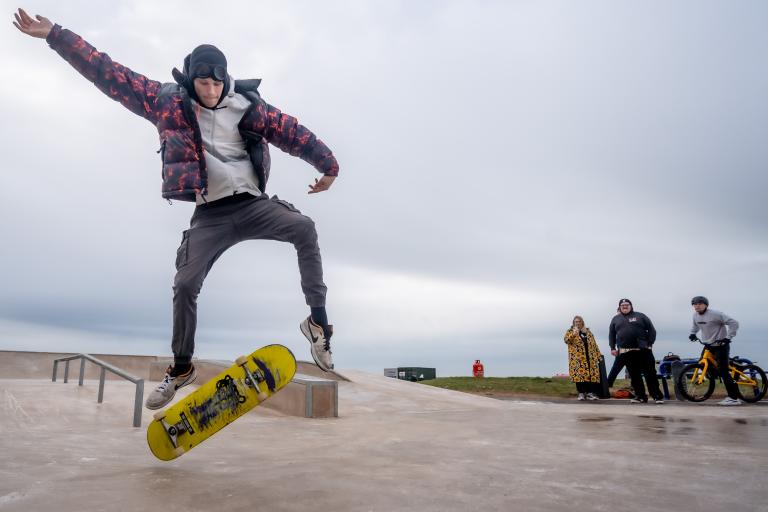 Boy jumping through the air on his skateboard