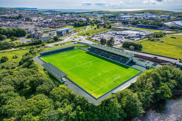 artists impression of the new Cumberland sports village. The picture shows a sports stadium with seating.