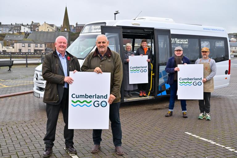 Cllr Andy Semple and Cllr Mark Fryer holding Cumberland Go Signage