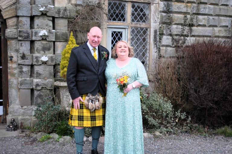 Kenny and Lisa Macleod standing outside their wedding venue