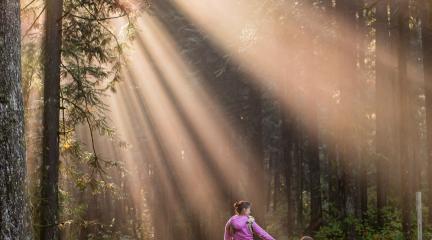 Mam and child walking in a forest