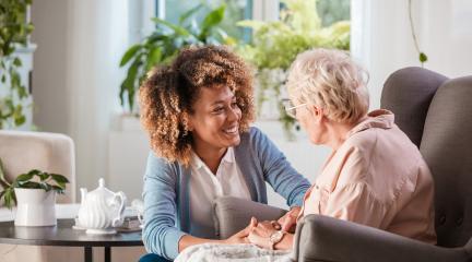 Old woman talking to female carer