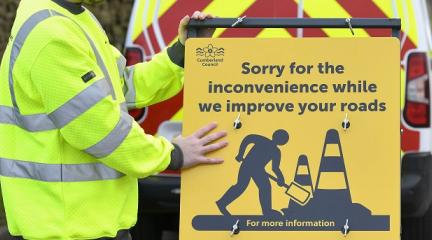 man with road sign