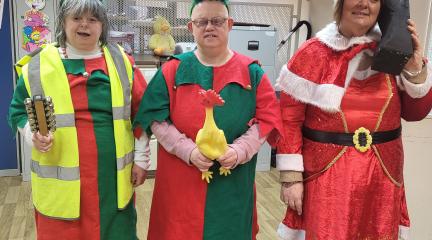 Dragonfly drama's cast in dress rehearsal wearing festive clothing and holding props