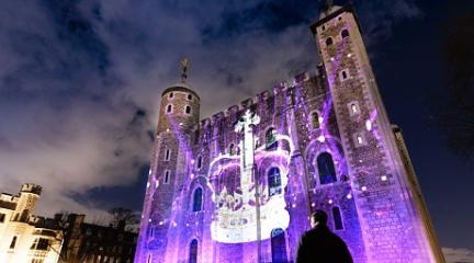 Building lit up in blue light with a crown