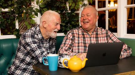 Two gentlemen talking over a cup of tea