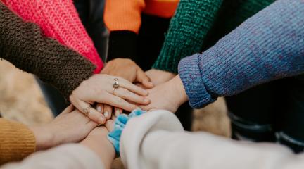 A circle of clasped hands