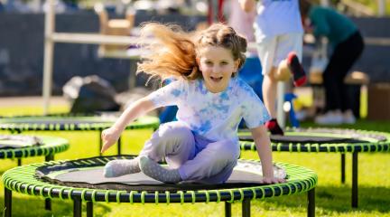 child on roundabout at wellbeing festival