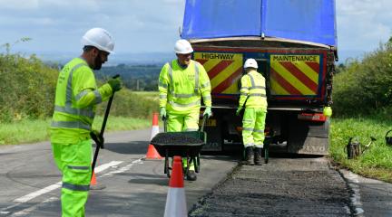Image is of highways team members road patching