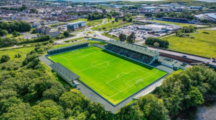 artists impression of the new Cumberland sports village. The picture shows a sports stadium with seating.