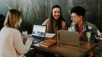 three adult learners at a table