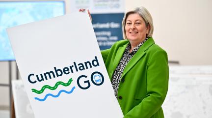 Denise Rollo with Cumberland Go poster