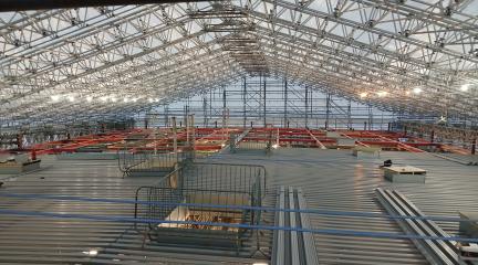 The Sands Centre auditorium roof - the first layer of roof panels being installed 