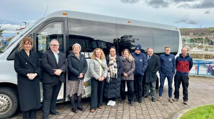 Department for Transport visit Cumberland - team photo stood in front of Cumberland Go bus