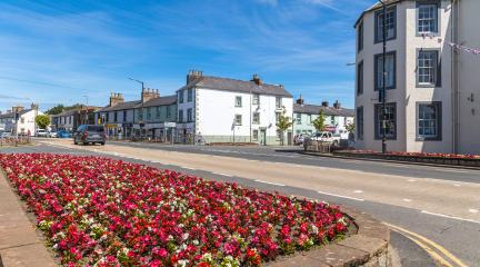 The A7 in Longtown, with a flower bed in the foreground