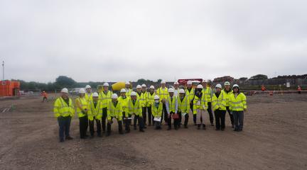 people stood at the port of Workington site which is to be developed in hi-viz jackets and hard hats
