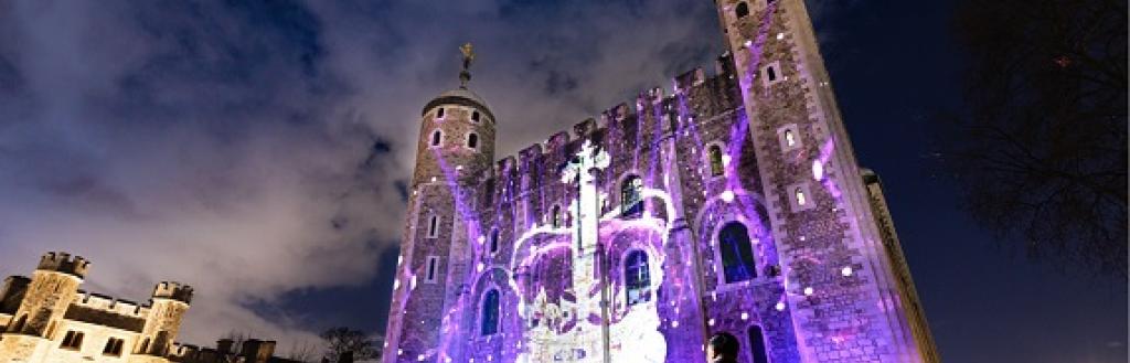 Building lit up in blue light with a crown