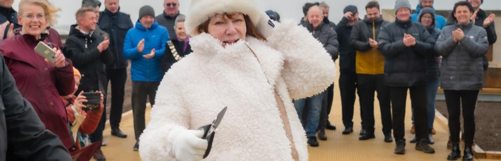 Cllr Carni Carron-Holmes cutting the ribbon on the Maryport Boardwalk