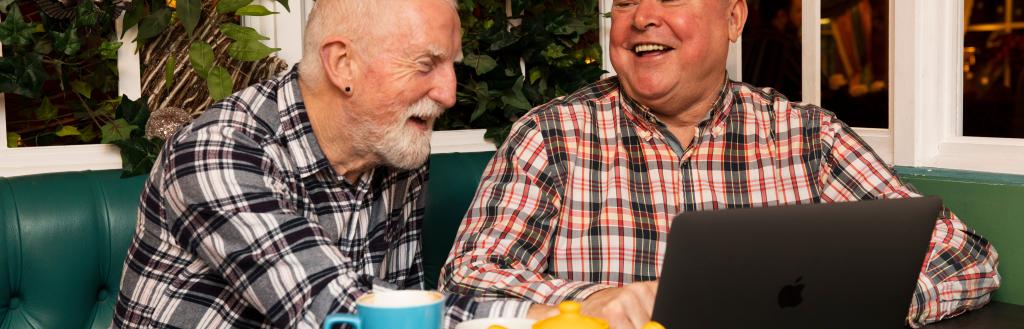 Two gentlemen talking over a cup of tea