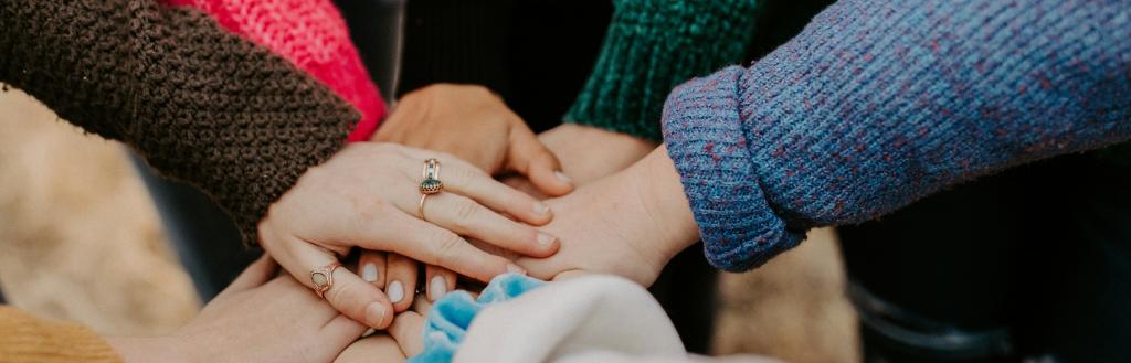 A circle of clasped hands