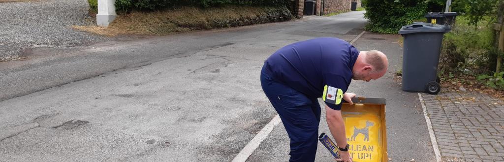 Enforcement team member placing a sticker
