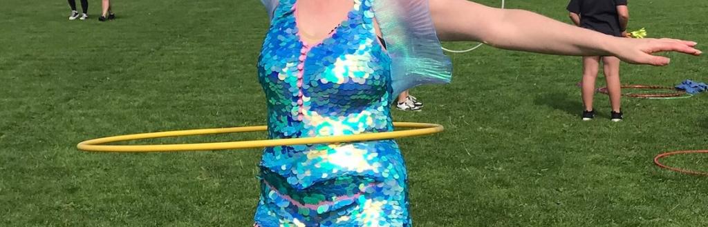Street entertainment at the 2024 Whitehaven Wellbeing Festival. A woman hula hooping.