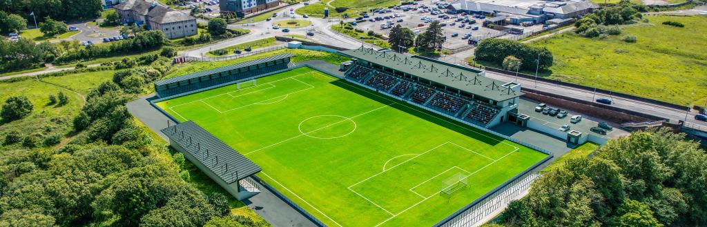 artists impression of the new Cumberland sports village. The picture shows a sports stadium with seating.