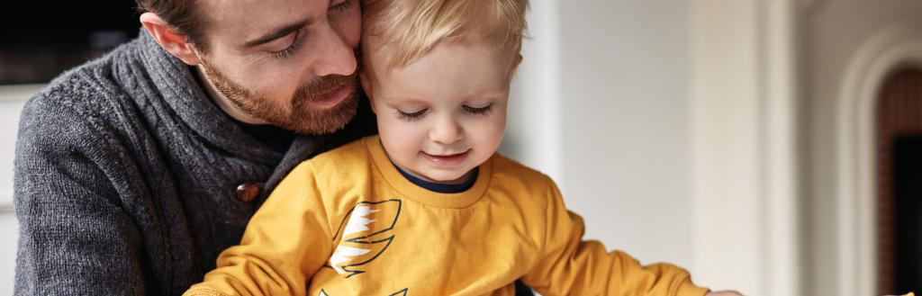 Man reading to his son