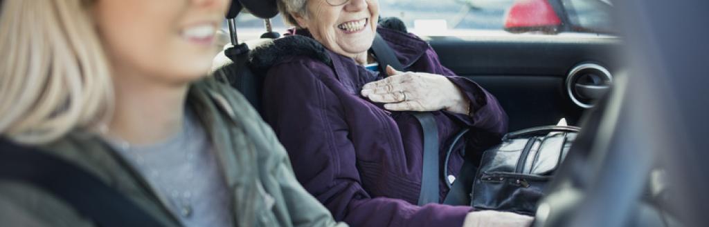 young woman driving an elderly lady