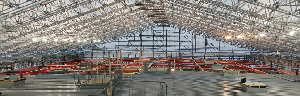 The Sands Centre auditorium roof - the first layer of roof panels being installed 