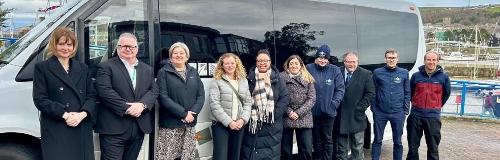Department for Transport visit Cumberland - team photo stood in front of Cumberland Go bus
