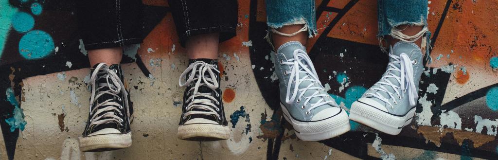 Young people's lower legs, in jeans and Converse shoes
