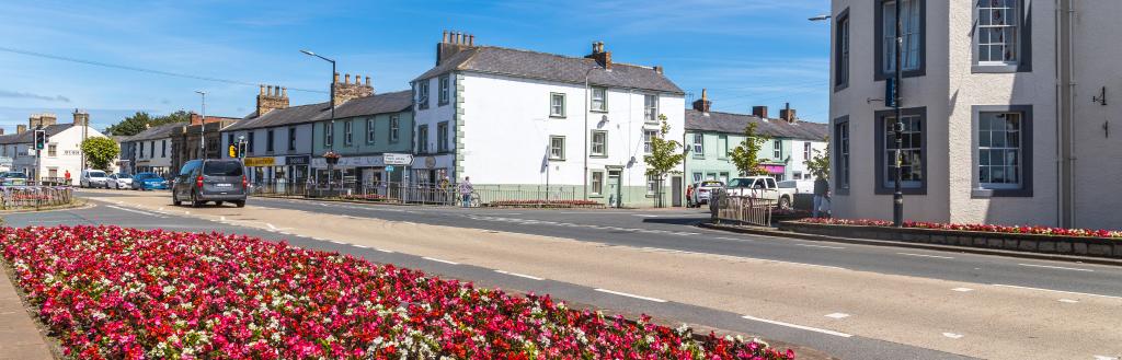 The A7 in Longtown, with a flower bed in the foreground