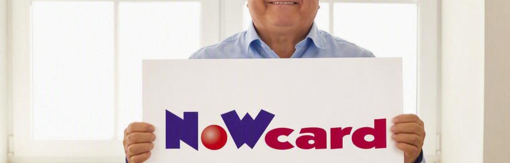 Man holding a now card
