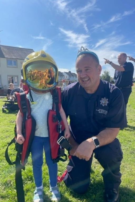 A fire officer and child at Ewanrigg Operation Respect 2023
