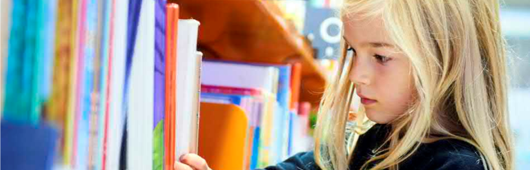 Child looking for a book