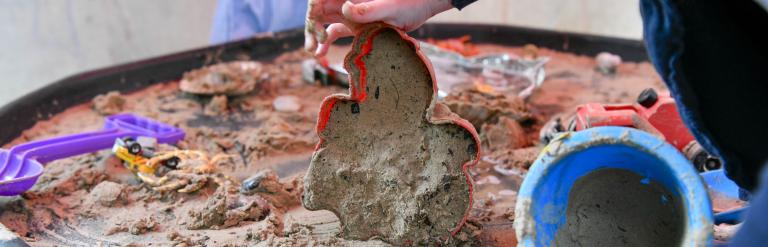 Two children playing in a sand tray